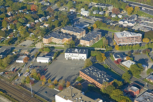 Fairfield Metro Center photographed at Low-level from the air. Office complex with parking near train depot and I-95 in New Jersey. Wittek Development, LLC.